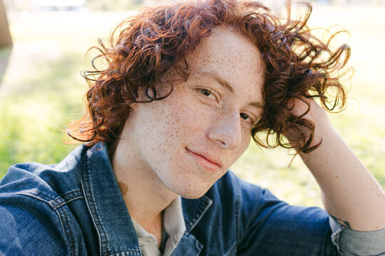 Smiling redhead man with curly hair