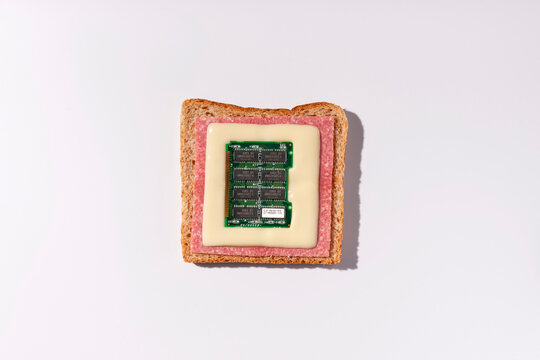 Circuit board on cheese and salami toast showing digitalisation