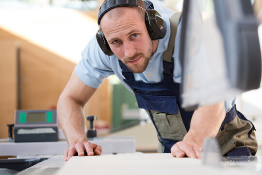 Craftsman working at circular saw
