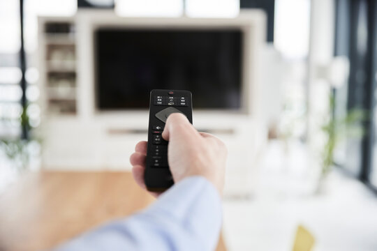 Man using remote control at home