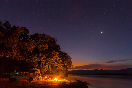 Zimbabwe, Urungwe District, Mana Pools National Park, camp fire at riverside of Zambezi at night