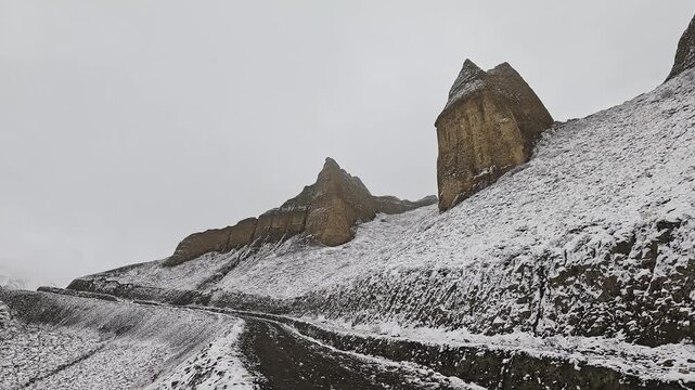 POV driving snowy switchback up Mui La (Muya La) pass in cloud, Upper Mustang, Nepal