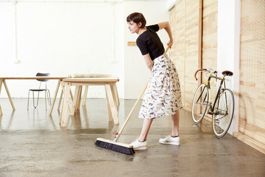 Woman sweeping in a studio