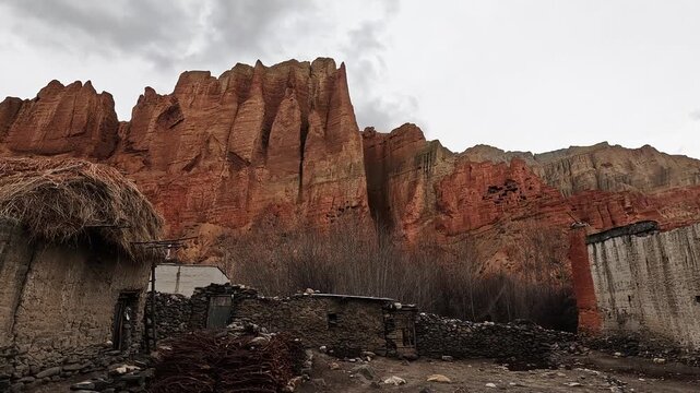 Traditional mud and stone houses below red sandstone cliffs, Dhakmar, Upper Mustang, Nepal