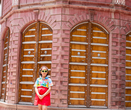 Little girl posing outside the historic Rampuriya Haveli in Bikaner, Rajasthan, India
