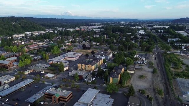 Active rail lines and arterial streets intersect near historic downtown Kent, Mt. Rainier background. Multi modal connectivity underpins economic development for urban hubs found throughout WA