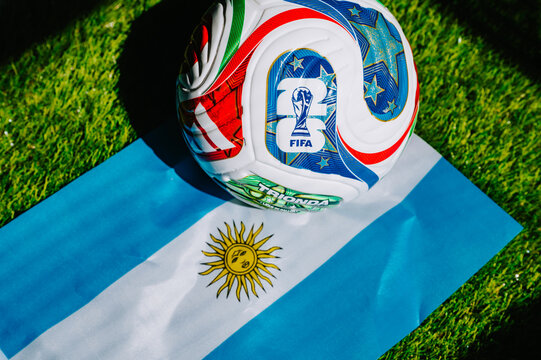 FIFA World Cup 2026 official match ball placed on Argentina national flag on green grass before international football tournament. Illustrational editorial photo