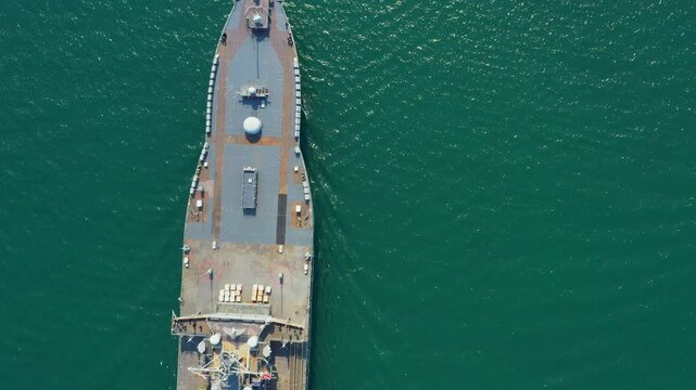 Amphibious Assault Ship. Navy aircraft carrier dominates serene expanse of blue sea, accompanied by support vessel. This powerful navy aircraft carrier evokes sense of strength and maritime capability