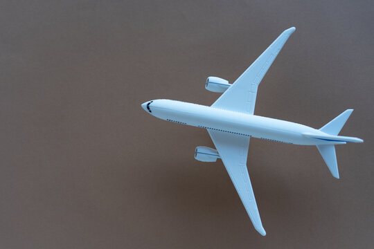 Image of an airplane against a brown background in landscape format