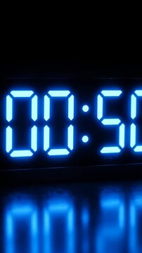 Blue digital timer showing fifty four seconds on black.