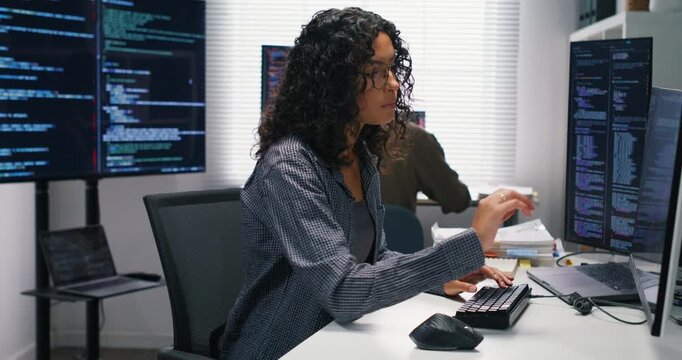 Man and woman engineers exchange advice on algorithms data pipelines application design cloud services and security strategies while coding and documenting solutions