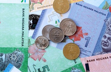 Malaysian ringgit money banknotes and coins on table. Malaysia cash bills of MYR currency © Viktor