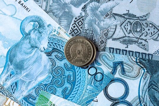 Kazakhstani tenge money banknotes and coins on table. Kazakhstan cash bills of KZT currency