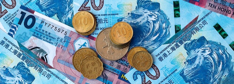 Hong Kong dollar money banknotes and coins on table. Hong Kong cash bills of HKD currency