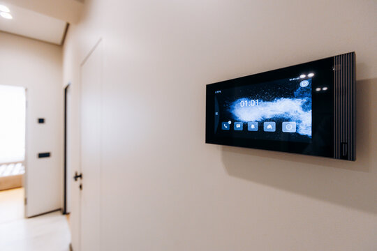 Wall mounted smart home control panel in modern hallway with touchscreen display, ambient lighting, and clean contemporary apartment interior, with smarthome, control, panel, touchscreen detail