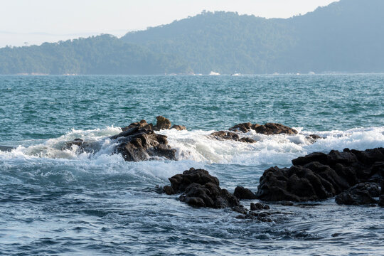 Rocky headlands and rocks are struck by powerful waves that crash with energy. Angra dos Reis &ndash; Rio de Janeiro, Brazil.