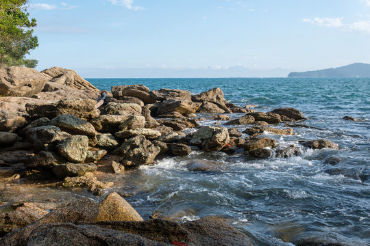 Rocky headlands and rocks are struck by powerful waves that crash with energy. Angra dos Reis &ndash; Rio de Janeiro, Brazil.