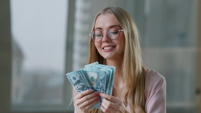 Joyful rich Caucasian business woman counting money in office smiling happy businesswoman female employer girl manager count dollars cash at workplace lady enjoying work salary jackpot lottery winning