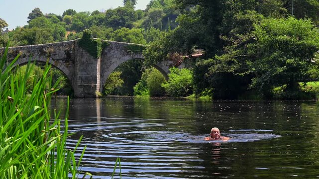 Woman Swimming in the Arnoia River to Cool Off During a Hot Summer Heatwave in Allariz Galicia Spain