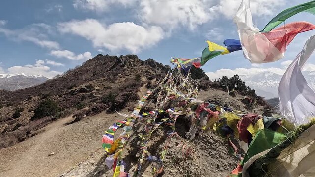 Multiple prayer flags streaming wind snow mountains Dajori La Buddhist spiritual