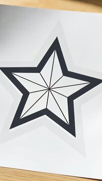 Vertical video: Lifting right hand and bending paper toward lens on wood table, revealing star warp