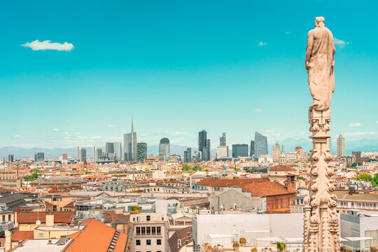 Panoramic cityscape view of modern Milan skyline from the historic Duomo rooftop.