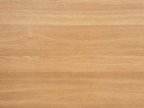 Light oak wood texture background. Natural wooden panel surface with horizontal grain pattern. Clean brown laminate or veneer backdrop.