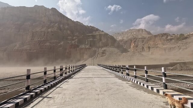 Bridge crossing in Kali Gandaki sandstorm, sand flying, dramatic cliffs, Upper Mustang Nepal