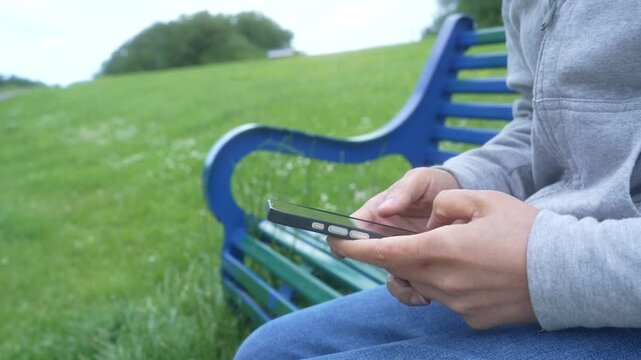 Person using smartphone outdoors for email management, AI assistant, business communication, mobile workflow, cloud collaboration, remote work, secure messaging, productivity and digital technology.