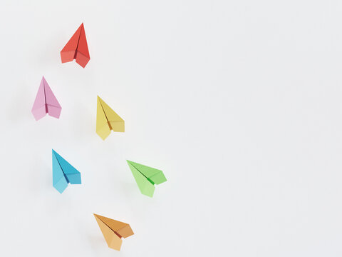 Six Pastel Origami Paper Planes Scattered On Plain White Background