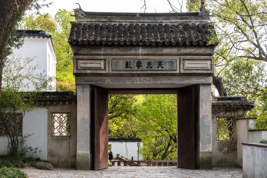 Stone entrance gate and tiled roof at Tiger Hill, Suzhou, China in spring