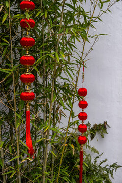 Red lanterns beside bamboo and white courtyard wall, Jade Buddha Temple, Shanghai, China