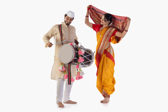 Portrait of Maharashtrian couple playing drum and dancing