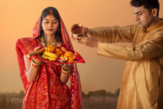 Couple from Bihar offers prayers to the  sun  in the  early morning hours during  Chhath Puja festival