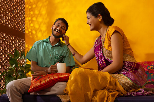Gujrati woman pulling cheek of her husband