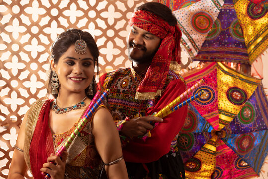 Portrait of Gujrati couple with dandiya sticks