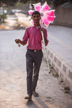 Male vendor selling cotton candy on the street