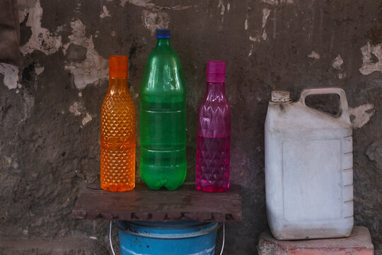 abstract photograph of three bottles lying on roadside 