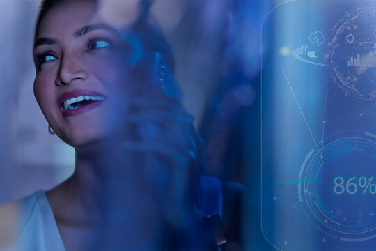 Businesswoman talking on smart phone with icons on virtual screen