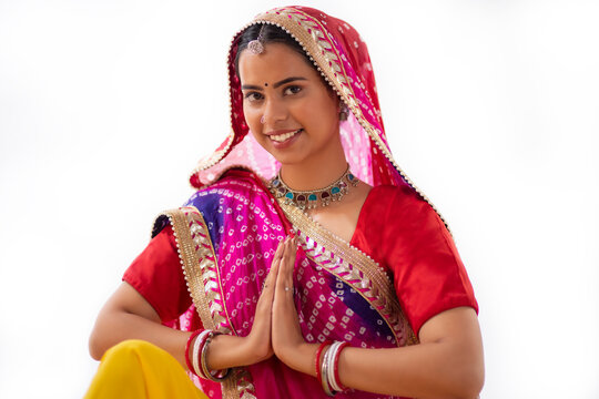 Portrait of Rajasthani woman greeting against white background