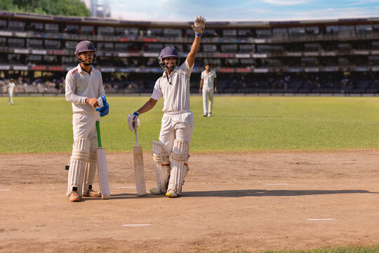 Batsman waving to the Pavillion from the pitch ,during a cricket match