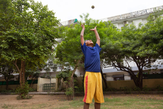 Portrait of a boy preparing to take a catch the ball during a cricket match