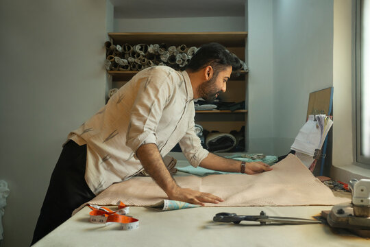Fashion designer working on the pattern-making table 