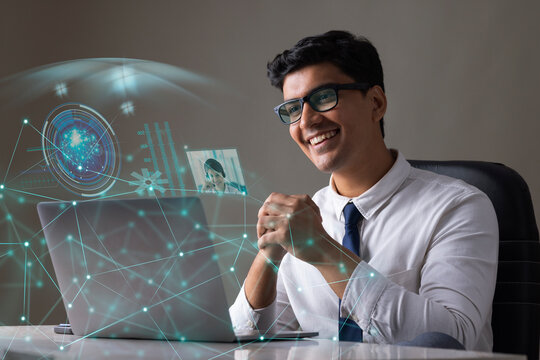 Businessman working on laptop computer with icons on virtual screen