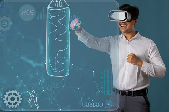  Man wearing VR headset and punching at digital Screen 