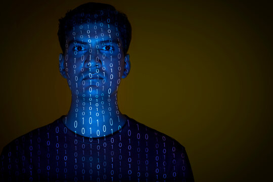 Close-up of a man with binary code reflected on his face