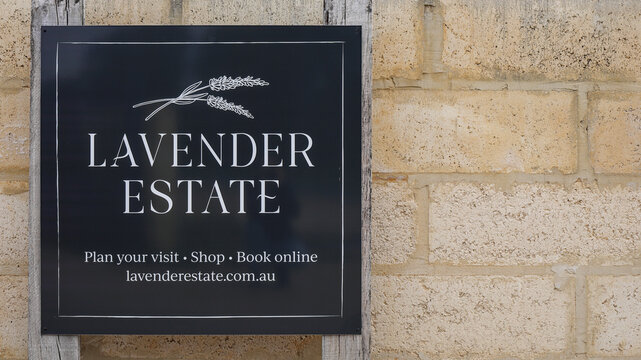Yanchep, Western Australia, Australia - July 11 2026: Black metal sign, promoting lavender farm, estate. Rustic limestone brick wall. Travel, tourism, destination