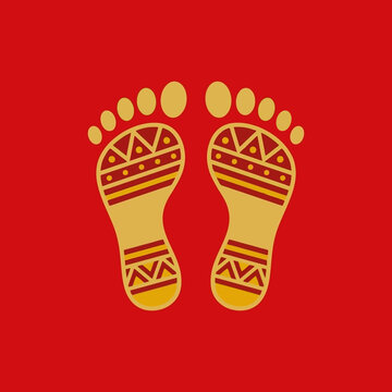 Traditional golden Lakshmi footprints on a red background for Diwali