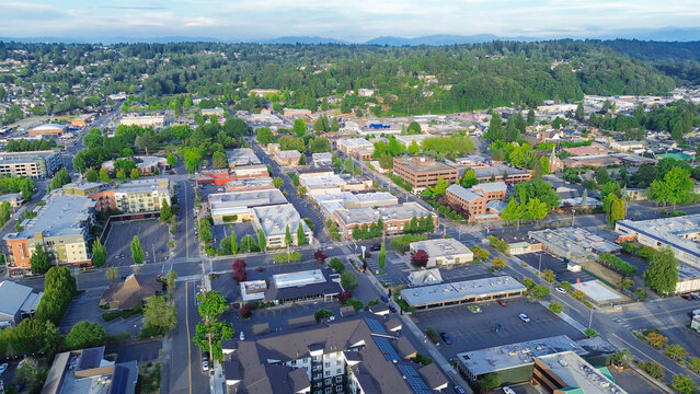 Low rise professional buildings anchor historic business zones near downtown Kent, suburbs Seattle. Dense mixed use development signals ongoing neighborhood transformation occurring throughout WA