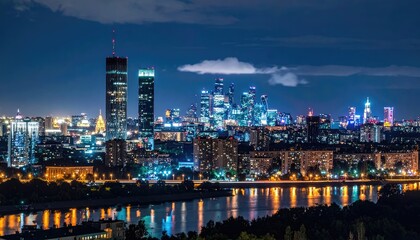 Fototapeta premium Modern City Skyline at Night with River Reflections.
